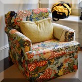 F54. Upholstered chair with pattern of flowers and dragons. 24”h x 32”w x 32”d 